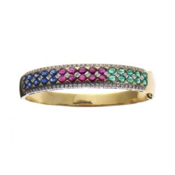 Two colour gold, sapphire, ruby and emerald bangle